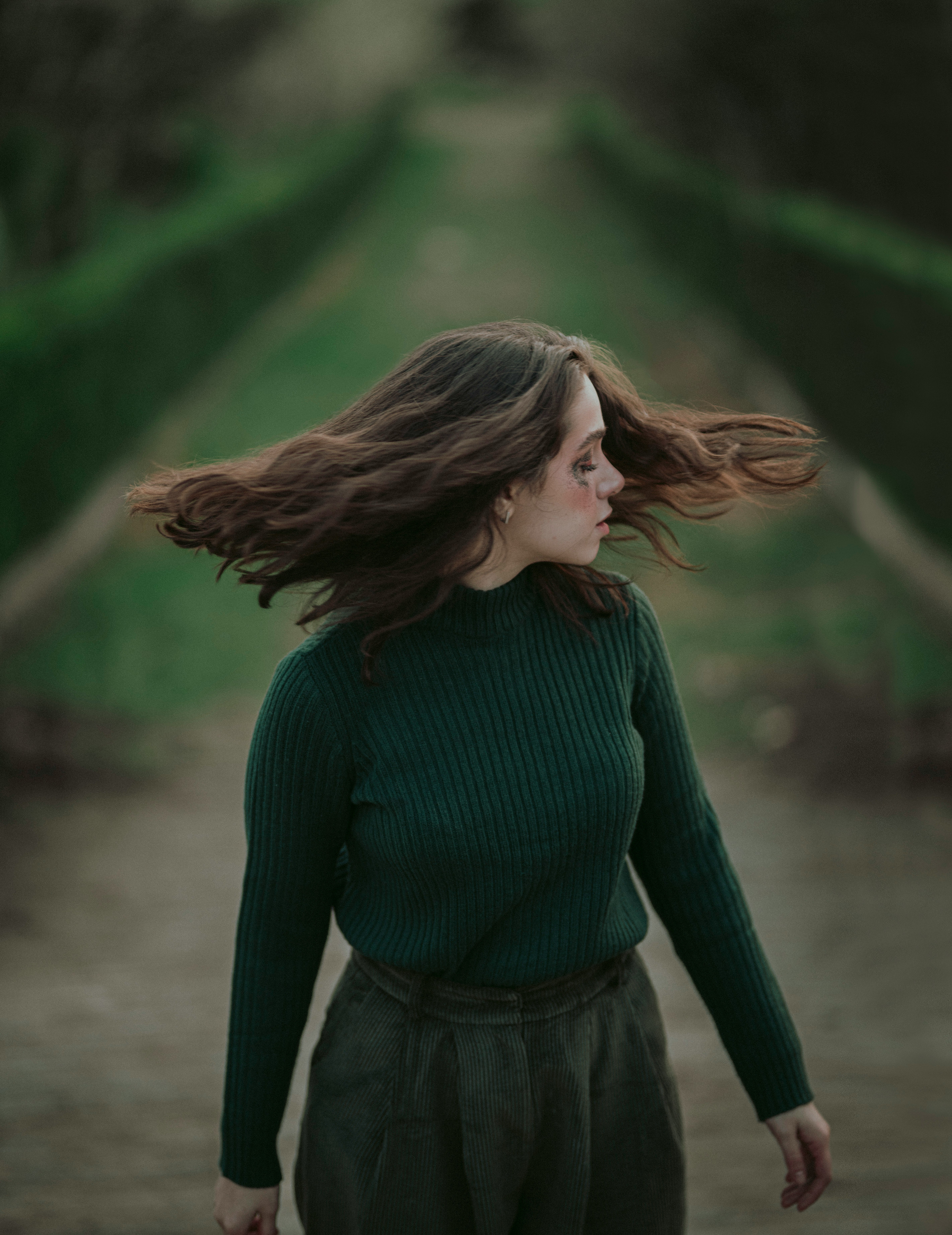 woman in green long sleeve shirt and black skirt